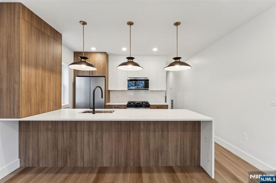 Stop scrolling! The "rental gods" have smiled upon you with 84 Hollywood Avenue, Unit 1. This brand-new 2025 construction feels like it was designed by someone who actually listened when people said, â€œI just want space.â€ The walk-in closets are so large that you may briefly forget which room you came from. The main level has bright finishes, brand-new stainless steel appliances, and an in-unit washer and dryer so you can retire from the laundromat circuit forever. The lower level opens into an enormous studio space that can transform into whatever your imagination allows: workspace, hobby space, peaceful bunker, or the repository for all the items you swear youâ€™ll organize someday. Parking is no joke either, with a private garage built to house two full vehicles. Outside, the backyard stretches wide, encouraging spontaneous lounging. With quick access to the Parkway, 280, NJ Transit buses, a nearby gym, and local places of worship, Unit 1 makes saying â€œyesâ€ surprisingly easy.