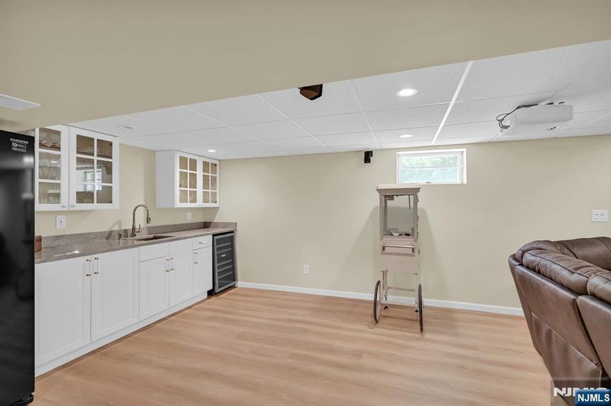 Discover this stunning 4-bedroom, 3-bath split-level home perfectly nestled in a peaceful, sought-after neighborhood, complete with a circular driveway for added convenience and curb appeal. Inside, you'll find a formal living room and dining room, a spacious kitchen ideal for cooking and entertaining, and generously sized bedrooms with updated bathrooms. The home also boasts a bright lower-level family room with direct access to the large patio, perfect for outdoor gatherings. The expansive lot offers plenty of space to add a pool. The large finished basement features a wet bar, abundant custom-made closets, and an impressive walk-in closet for exceptional storage. Recent upgrades include a NEW ROOF, NEWLY SEALED DRIVEWAY, and NEW EPOXY GARAGE FLOORING. Fireplace, Chimney & Flue AS IS, with NO Known Issues. Move-in ready and beautifully maintained, this home blends style, space, and location a rare find you won't want to miss. Schedule your showing today! HIGHEST AND BEST OFFERS DUE WED 08/20 @ 12 PM (NOON)