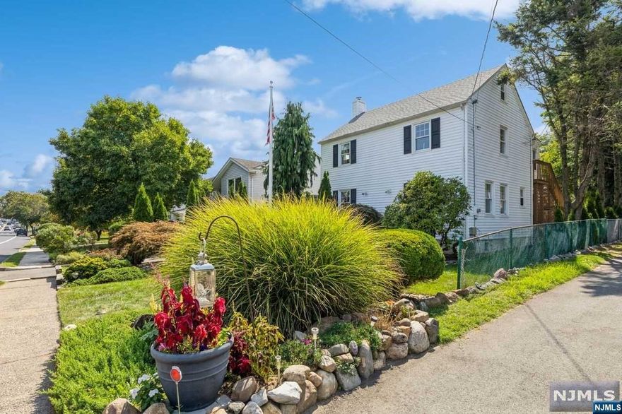 This elegant single-family home is located in salt after Athenia section of Clifton walking distance to Clifton Senior high school and New York City train this beautiful side hall. Colonial is the perfect mix of timeless, charm and modern amenities. As you approach the front door, you are greeted by a beautiful brick front porch with built in brick planter. Upon entering, you are warmly welcome by a bright, open floor plan. Meticulous attention to detail is present in the kitchen with white tile floor, warm brick accent, dark wood cabinets, and quartz countertops, as well as stainless steel appliances that complete this beautiful kitchen. adjacent to the kitchen is the room with 12 foot ceilings and floor ceiling built in bookshelves. The sun filled great room looks out upon the deep, private backyard with enormous patio perfect for entertaining.