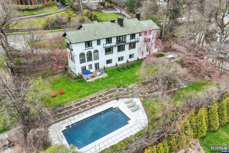 NO OPEN-HOUSE. 75 Lloyd presents an extremely rare opportunity to own a private, sun-soaked, modern + turnkey estate in NYC's most in-demand suburb. This fully renovated & professionally redesigned Mediterranean manse boasts endless amenities that are impossible to recreate: breathtaking views of the NYC skyline from every angle, a sprawling open-concept floor plan drenched w around-the-clock sunlight + an unbeatable location on Lloyd Road, Montclair's most prestigious address. Enjoy resort-style living + be transported to your very own entertainer's dream home, complete with leveled + lush landscaping with a heated inground pool. Located only 17 miles from Manhattan, this spectacularly renovated & redesigned residence by an award-winning artist, offers endless amenities + upgrades: a Chef's kitchen complete with new designer appliances, fully open floor plan to support modern living, vaulted ceilings, natural light pouring through massive custom windows, a luxurious primary suite