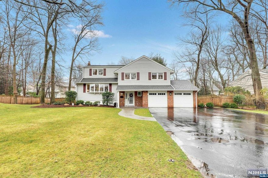 Welcome to your dream home! Nestled on stunning property, this absolutely beautiful 4-bedroom, 2-and-a-half-bathroom home is a testament to meticulous care and comfort. From the ground level boasting a powder room and family room with sliding glass doors to the beautiful stone patio and wrap-around deck, to the sunlit living room, kitchen with an island open to the dining room on the first floor, this home is designed for modern living. The second floor features a primary suite with en-suite bathroom, along with two additional bedrooms and a hall bathroom. The third floor offers a very large, versatile bedroom that can be used as a guest room, home office or playroom. For added convenience, there's an office, laundry, and storage space in the basement.Located in a sought-after neighborhood, this home offers easy access to Demarest's top-rated schools,shopping and transporation. Don't miss the chance to make this meticulously cared-for home yours.