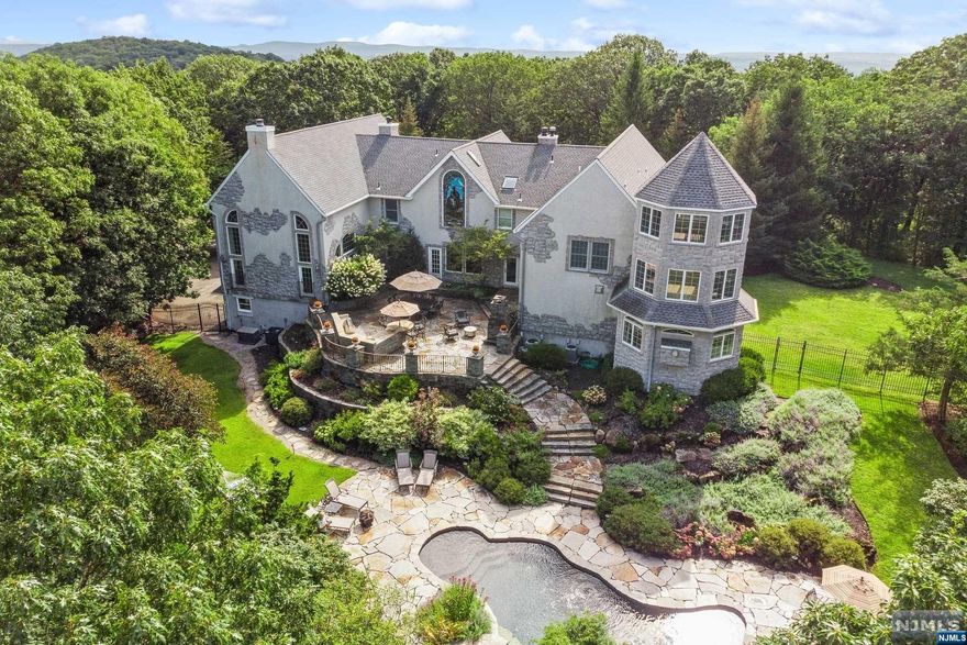 Perched atop ten acres this exceptional property offers the ultimate in sophisticated serenity. From the circular drive,step into grand foyer of this chaeteau inspired custom home and into your luxury lifestyle! The main level is punctuated by a grand ballroom w/ fireplace and soaring windows and ceilings with additional loft living room w/ fireplace. The kitchen features Wolf appliances, granite and quartz breakfast bar and powder room. The 1st floor also offers a cozy family room w/a wood burning stove and convenient powder room,along with a quiet den also with a fireplace and custom bar! The adjacent dining room provides an elegant space for any occasion.The 1st floor offers a guest bedroom with an ensuite bathroom,laundry room,and the 3-level primary suite w/ fireplace,walk-in closets and en suite bathroom w/ Jacuzzi,dual vanities and staircase to the second floor multi-purpose space and turret room. Two additional bedrooms,two w/ensuite bath, can be found on the second floor