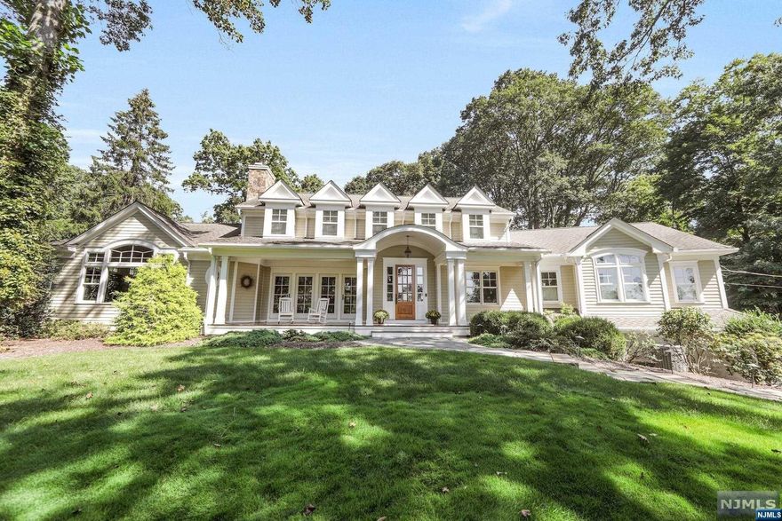 Majestically sitting high on top of a knoll, this beautiful 4 BR, 3 FBA Center Hall Colonial w/an inviting front porch & mature manicured landscaping is breathtaking! It offers High ceilings, Brazilian Cherry floors & great attention to detail. DR has French Doors that access the front porch & a Gas FPL, Home Office is Lg, Great Rm has a vaulted ceiling, wet bar, Wood/Gas FPL, lots of natural sunlight and access to lawn area & backyard, great for entertaining! Designer Kit has a Lg Center Island w/sink, 2 Dishwashers, Top of the line Appliances, Walk in Pantry & wall of windows overlooking backyard. Mudroom, Desk station, FBA & MBR Suite w/vaulted ceiling, french doors that lead to bckyrd, 2 Walk in Closets & MBA w/soaking tub, double sinks & a steam shower complete the 1st floor! 2nd floor landing has a sitting area, FBA & 3 great sized BRms. FFBsmnt w/Media Area, Gym & Bonus Rm. Backyard w/pool, 2 Built in BBQ's, outdoor shower...entertainer's dream!3 Car Gar. A must see home!