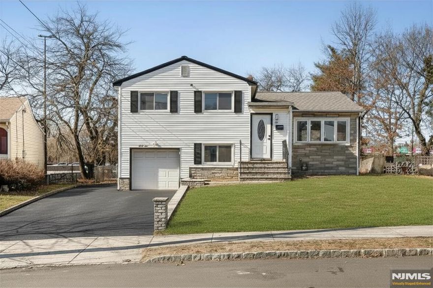 Beautifully renovated 5-Bedroom Split-Level home in the heart of Hillside, Union County. This spacious style home offers a versatile layout and modern upgrades throughout. The main level features a bright living room with cathedral ceilings, dining area, and an updated kitchen complete with quartz countertops and stainless steel appliances. The second level includes three spacious bedrooms, a full bathroom, and a large linen closet. On the lower level, you'll find two additional bedrooms, a full bathroom, direct access to the garage, and an inviting three-season enclosed porch that leads to the backyard perfect for relaxing or entertaining. The finished basement provides even more living space with a flexible office or playroom area and a dedicated laundry room. Ideally located between Route 22, I-78, and the Garden State Parkway, this home offers excellent commuter access to Newark Airport, Jersey City, and New York City..