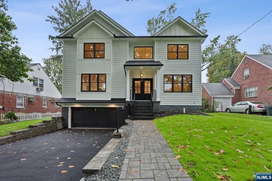 Welcome to your dream home, a sanctuary of natural light and modern elegance nestled in the heart of Teaneck. The beautiful entry hall leads you into the banquet-size dining room, which is perfect for entertaining, with its built-in buffet/washing station. The dining room flows into the cozy and inviting family room, with a fireplace, that overlooks the large backyard. The chef's kitchen is equipped with double stainless appliances, top-tier finishes, and a spacious walk-in pantry. Private office/guest room with an adjacent powder bathroom. The first floor is designed with 9-foot ceilings, enhancing the openness of the space. Upstairs is a large master suite with walk in closet and spa like bathroom. Three more oversized bedrooms and two full bathrooms. Convenient laundry room. On the third floor is one more bedroom and full bathroom, in addition to a rec room. The basement has a huge rec room, office and full bathroom. Located near parks, transportation, and houses of worship.