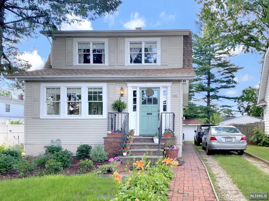 Location! This freshly-landscaped Colonial style home sits at the end of a cul de sac close to NYC transportation, schools, shopping, and major highways! An urban oasis, the home's enclosed front porch greets you as you enter its glowing sunlit rooms. The gleaming hardwood floors of the large living room flow into the gracious formal dining room adjacent to a sunny and bright eat-in kitchen. A spacious deck and private yard with patio is perfect for entertaining, barbecuing or just relaxing. Partially finished basement with newly renovated full bath offers plenty of storage space. Master bedroom offers an additional sitting area and possible office space!