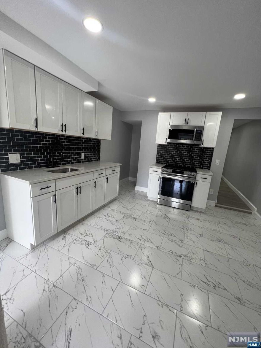 A beautifully renovated single family row home in a desirable section of Kearny! The layout features: 2 bedrooms, 1 full bathroom, living room, eat in kitchen and dining room. The house feature recess lighting; brand appliances; new furnace and water heater. The backyard offers an amazing enclosed space, perfect for entertaining. Situated in an excellent location, you'll enjoy easy access to local amenities, houses of worship, schools, shopping centers and transportation. Don't miss the opportunity to make this house your new home sweet home in Kearny! LOW TAXES.