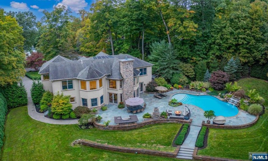 Stunning 10 years young custom estate nestled at the end of a serene cul-de-sac. Enter the grand 2 story foyer & be captivated by the 2 stry great rm w/stone fp & wall of windows. Doors open to a private backyard oasis to entertain in style. Bluestone patio w/ outdoor FP, built-in kitchen, custom saltwater pool with waterfall & fire bowls surrounded by lush landcape. Inside, the chef's kitchen boasts high-end applncs w/blt in coffee maker, oversized seated islnd & btlrs pantry. Banqt size DR, LR, 1st fl BR ensuite, mud room compl the 1st floor. The 2nd fl offers a grand primary suite w/ 2 bathrooms & 2 walk-in closets. Two addt'l ensuite bedrooms, an addt'l bedroom, full bath, & an oversized laundry room w/ office space. The lower level is equipped with a theater room, wet bar, gym, full bath, & salon area. Additional amenities include a 3-car garage, generator, smart home features, circ paver DW & your own chicken coop to cultivate your own eggs. Lower taxes too!