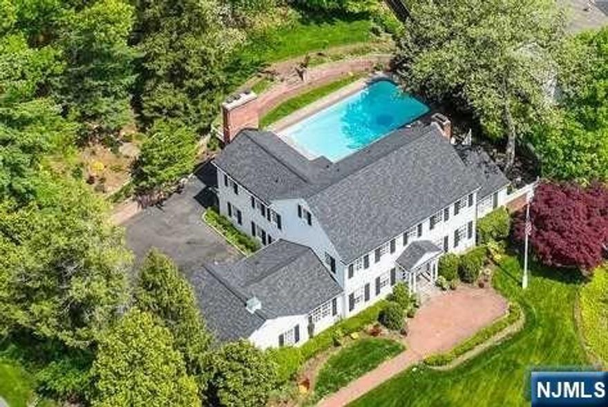 Sensational custom colonial situated on 2/3 acre of gorgeous property. Exquisite designer finishes with updates and upgrades throughout + fabulous outdoor spaces including inground pool! Located on quiet street in Hartshorn section, this home provides luxurious living without ever leaving the property. Front-to-back Living Room overlooks rear yard and opens to Office/Sunroom with direct patio access. Formal Dining Room provides access to kitchen and is open concept to stunning Family Room with beamed ceilings and easy access to pool + to 2-car garage and parking. 1st floor en-suite Bedroom with renovated bathroom. 2nd level features Primary Wing with fireplace, balcony, 4 closets and bathroom with tub and separate shower; 3 other bedrooms (1 en-suite) all have large closets + additional Full Hall Bath. Lower Level Rec Room with large storage area + laundry area and utility bathroom. Spectacular yard and resort-like swimming pool, covered porch, blue stone patio and lush gardens.