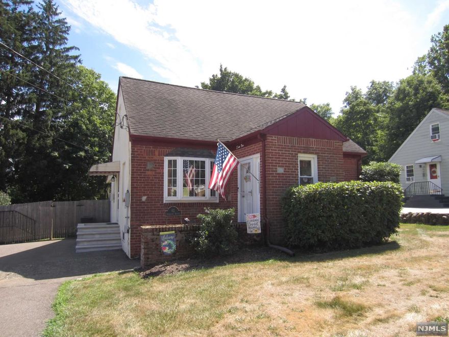 Welcome home to this well maintained, move-in ready Cape Cod style home! First floor features entrance vestibule/mud room w/coat closet, bright & sunny living room w/bay window, large formal dining room, neutral full bath w/pocket doors, bedroom & heated sunroom! Entry to backyard through sunroom. (Hardwood floors under carpets in DR, LR & 1st floor BR only) The 2nd floor features 2 generous size bedrooms, full bath and tons of storage! Basement is partially finished w/ rec room, storage room & laundry room. Basement refrigerator included! The large, fenced in backyard is perfect for entertaining! You will love the covered patio w/ceiling fan! Yard also has a private fenced area to store items. Oversized driveway to fit 6 plus cars. New entrance door and storm door. All 5 window AC's are included along with washer/dryer! Close proximity to William Paterson University, schools & restaurants! Fabulous low taxes!! Don't miss this one!