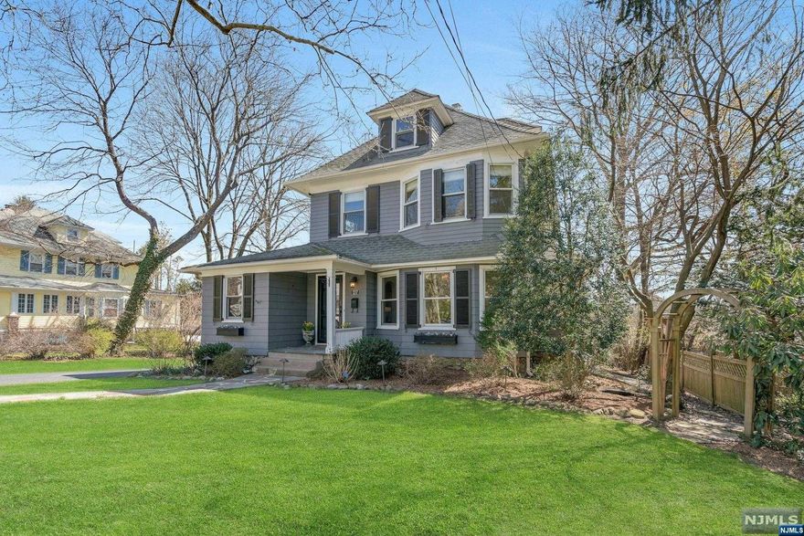 Welcome to this timeless Ridgewood colonial located on a local, tree-lined street just moments from downtown, train & schools. Classic features greet you from the moment you step inside, columned marble entry foyer, large updated windows, spacious DR & formal living room w fireplace, side porch for quiet reading or home office set up! The heart of this home is the large eat-in kitchen that flows into a grand family room with FP & built-ins, the perfect backdrop for entertaining & holiday gatherings! Lemonade porch flanks side of house with its own separate entry & access to mudroom, powder room & first floor laundry. Second floor boasts three bedrooms, hall bath & beautiful sun-drenched primary suite with FB and walk-in closet. Third floor has two add'l bedrooms & FB! Lower level is fully finished w/ high ceilings, FP & plenty of space for Rec room & gym! Outside is perfect for entertaining on the large patio w yard space & newer, oversized garage. Don't miss this beautiful home!
