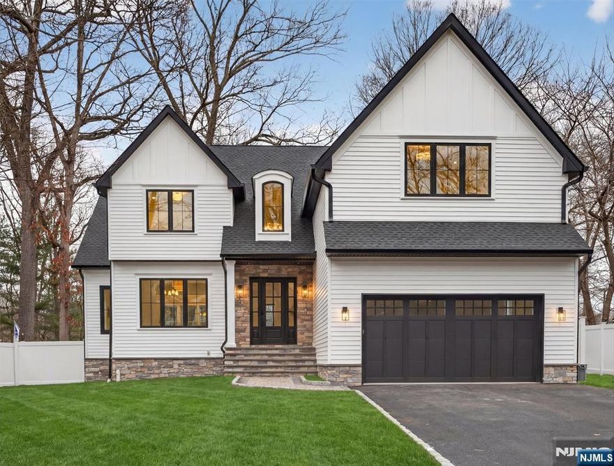 Stunning new construction offering over 5,300+ sqft of beautifully designed living space, blending timeless architecture with modern luxury. Grand-scale rooms, expansive Anderson windows, and refined finishes including custom millwork and elegant arched doorways create a light-filled, sophisticated atmosphere throughout. A two-story foyer sets the tone, opening seamlessly to the formal living and dining rooms, ideal for both entertaining and everyday living. The two-story great room features a soaring fireplace and walls of windows that flood the space with natural light. The gourmet kitchen is designed with a large center island, Thermador appliances, Taj Mahal countertops and abundant custom cabinetry. Sliding glass doors lead to a 550 sqft paver patio, offering indoor-outdoor living and views of the expansive backyard. The main level includes a private bedroom with ensuite full bath, perfect for guests, a home office, or multigenerational living, along with a powder room. Upstairs, the serene primary suite offers generous proportions, a double closet and a spa-inspired bath. A secondary bedroom features its own ensuite, while two additional bedrooms share a full bath. A second-floor laundry adds convenience. The finished lower level adds flexible living space with an additional full bath. A prime Ramsey cul-de-sac location close to shopping, dining, and NYC transportation complete this exceptional home! WANT MORE INFO? CONTACT LISTING AGENT NICOLE MINETTI @ 201-388-0077