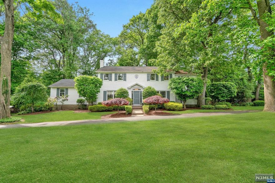 Elegant white brick-faced colonial offers timeless style and sophisticated finishes, perfect for those who love to entertain. One acre setting, this renovated home welcomes you with beautiful curb appeal and circular driveway, leading into a spacious layout filled with natural light. A front-to-back living room pairs seamlessly with the dining room, enhanced by a private office & cozy family room featuring built ins, wood-burning fpl & wet bar. A chef's delight, the high-end custom eat-in kitchen is equipped with concrete countertops, a large, seated island, professional Viking 6-burner range with griddle, stainless Kitchen Aid 42' refrigerator & more. Exit to the private bluestone patio for delightful alfresco dining and relaxation. The upstairs offers 4 bedrooms, including the tranquil primary bedroom with a spa-like bath showcasing slate-like floors and accents, jetted tub, and large shower. Add'l recreational space is found in the finished lower-level w/full bath. Don't miss!