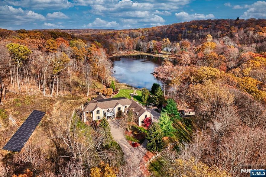 Set on nearly 15 acres of total privacy, this approximate 9,600 sq ft estate redefines lakefront luxury. With three finished levels, six bedrooms, and seven baths, the home offers an extraordinary blend of scale, craftsmanship, and tranquility surrounded by nature. A grand two-story foyer with a double bridal staircase sets the tone for the homeâ€™s impressive scale. Beyond the foyer, the massive two-story great room showcases walls of windows framing stunning lake and property views, flooding the space with natural light. The gourmet eat-in kitchen is designed for both beauty and function, showcasing stainless steel appliances and a large center island. A spacious formal dining room offers the perfect setting for hosting. The family room connects seamlessly to the billiards roomâ€”an ideal layout for entertaining. This level also includes an office and a powder room. Occupying the full left wing of the home, the primary suite is a private retreat that stretches from front to back. It offers multiple walk-in closets and a spa-inspired bathroom complete with dual vanities, a soaking tub, and a large walk-in shower. The upper level also includes a gym, two additional en suite bedrooms, a Jack-and-Jill bedroom suite, and a laundry room. The fully finished lower level features a custom kitchen and bar area, a theatre room, an additional bedroom, full bathroom, and ample storage. Enjoy a custom pool, cabana, and a private beach along the lakeâ€”creating the ultimate escape at home