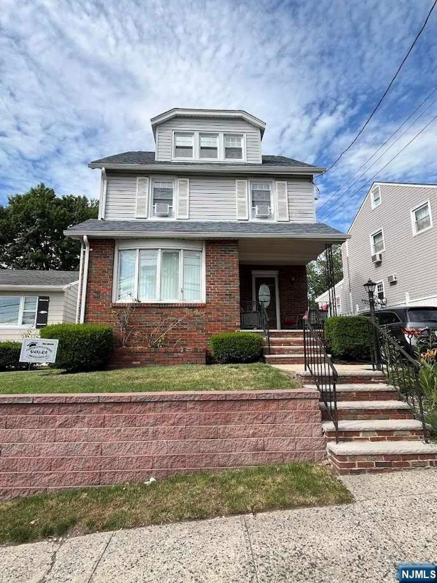 This charming 7 Room Colonial home, features 4 levels of living space including a second kitchen and half bath in the finished basement! The interior includes a spacious living room with hardwood floors, a modern kitchen with a breakfast bar, and dining room. On the second and third floor you will find three bedrooms and an additional room perfect for an office or nursery with a newly updated main full bath. Well maintained exterior including Newer roof, vinyl windows Plenty of storage areas throughout including an oversized garage. This home is conveniently located near shopping and commuter routes to NYC.