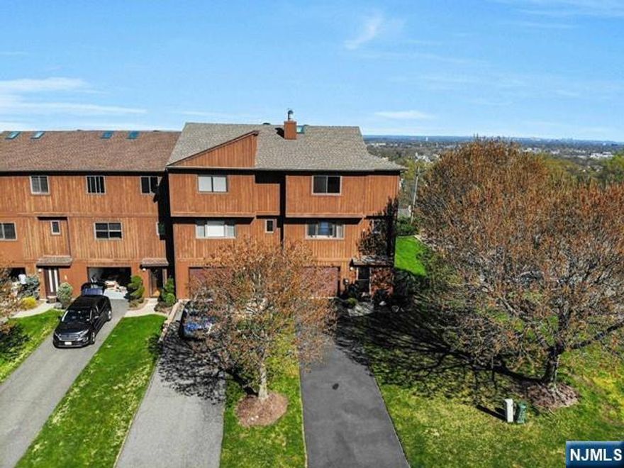 HIGHVIEW AT HAWTHORNE. 3 Bedroom, 2.5 Bath 'End Unit' Townhouse with panoramic view of the NYC skyline and sunrise from the rear deck. Features include hardwood and tile floors in the open Living Room/Dining Room area with a beautiful stone front fireplace. Ground floor has Family Room/Bedroom, Full Bath with Stall Shower and doors to the rear patio. The garage is attached and has hallway entry. 'HIGHVIEW AT HAWTHORNE' is conveniently located to major highways and public transportation. This is a beautiful end unit.