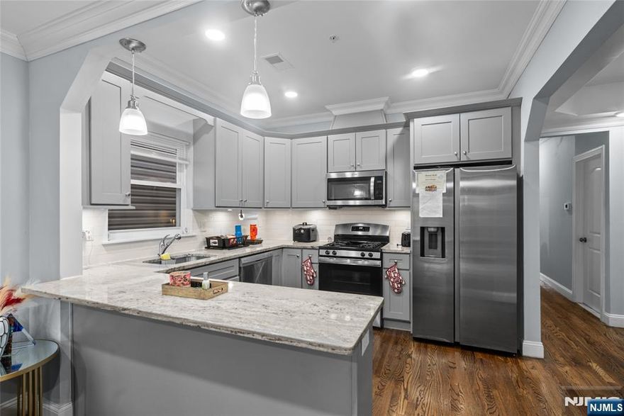 Newer construction two-family home offering modern design and excellent income potential. Each unit features 3 spacious bedrooms and 2 full bathrooms with open-concept layouts, hardwood floors, and abundant natural light throughout. The kitchens are equipped with stainless steel appliances, a breakfast bar on the 2nd and 3rd floors, and flow seamlessly into a separate dining room, perfect for everyday living and entertaining. Primary suites include walk-in closets and private en-suite bathrooms, while each unit also offers its own laundry for added convenience. Sliding glass doors on the ground floor provide direct access to a private, vinyl-fenced backyard, ideal for outdoor enjoyment. Additional highlights include balconies on both the 2nd and 3rd floors, a bonus 1-bedroom, 1-bath unit for extended living or added rental income, and a 2-car garage for off-street parking. Conveniently located on a quiet residential street just 10 minutes from Newark Penn Station, you'll enjoy an easy commute to NYC or Hoboken. Surrounded by local parks, delis, shops, and restaurants, with convenient access to bus, rail, and other transportation options this is a city living with a neighborhood feel!