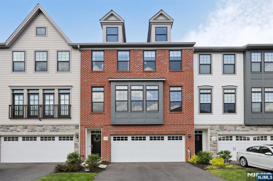 Contact Sarah for more information (201-788-9901) Discover contemporary comfort and style at 53 Cranberry Lane in the sought-after Village Springs community of Montvale. Built in 2023, this elegant three-level townhome features 3 bedrooms, 2 full bathrooms, and 2 half bathrooms, offering a thoughtful layout for both everyday living and entertaining. The main level welcomes you with sun-drenched, open living and dining areas flowing seamlessly into a designer kitchen. This kitchen was upgraded with high-end selections, including sleek quartz surfaces, premium appliances, and a generous island ideal for gathering. Step through sliding glass doors onto a private deck overlooking tranquil wooded sceneryâ€”your own quiet escape. Upstairs, the serene primary suite includes a spa-inspired bath and a spacious walk-in closet. Two additional bedrooms, a full bath, and a conveniently located laundry room complete the upper level. The lower floor offers a versatile recreation area with access to a covered patioâ€”perfect for relaxing or hosting guestsâ€”as well as a powder room, extra storage, and a two-car garage. Enjoy a peaceful setting with easy access to top-rated schools, shopping, dining, major highways, and local nature trails. Live in comfort, surrounded by nature, just minutes from everything Montvale has to offer.