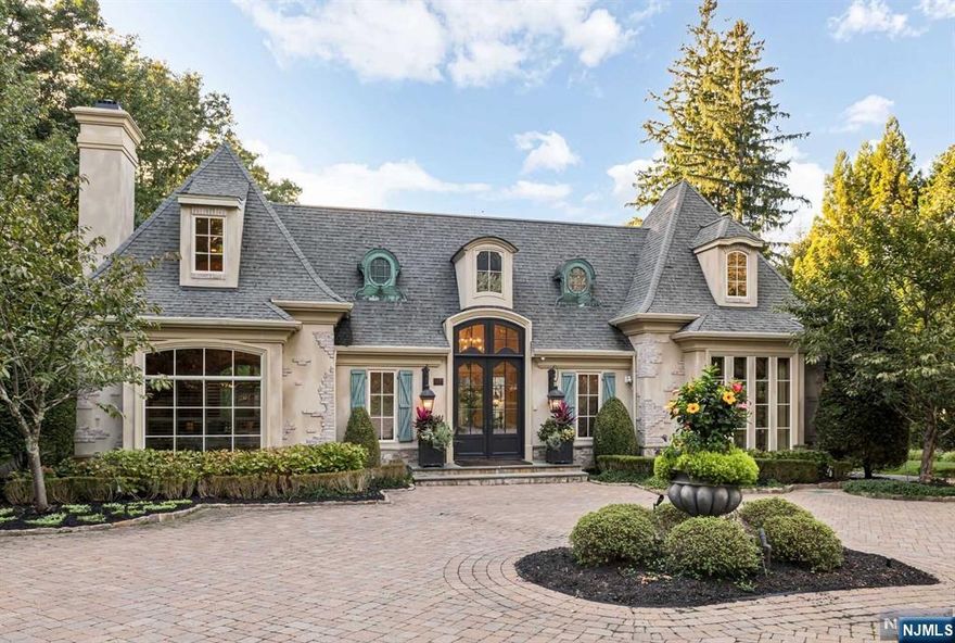 Welcome to 274 Woodside Avenue, an extraordinary 8,800 sq ft luxury estate in Franklin Lakes, NJ. This meticulously designed home offers sophisticated craftsmanship and modern comfort. A grand foyer with stone floors leads to a spacious living room filled with natural light, a formal dining room, and a custom butler's pantry. The gourmet eat-in kitchen features two islands, premium appliances, and flows into a sun-filled family room with French doors to the outdoor retreat, complete with a kitchen, fireplace, and lounge area. The primary suite includes dual walk-in closets and a spa-like bath. The finished lower level offers a wine room, bar, and media area. Additional highlights include a first-floor suite, 3-car heated garage, and whole-house generator.