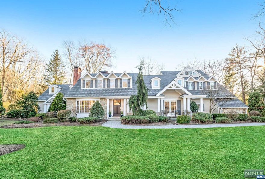 The home you have always admired can now be yours. Set on a level acre property, this elegant center hall colonial with over 5000 sq ft of living space boasts tons of curb appeal. Spacious, yet comfortable, you are greeted by an entry foyer with hardwood floors & large dining room with fireplace. The eat-in kitchen with island is truly the heart of this home with a cozy fireplace near the breakfast area & open to a great room with soaring ceilings & 3rd fireplace. There is also a cozy den, pantries, 1st floor BR/office, full bath, & half bath on this level. Upstairs,there are 4+ BRs, 3 full baths & laundry. The primary suite features a BR with 4 closets, separate walk-in closet & master bath with separate shower & tub. An adjacent room makes a wonderful sitting room, office or playroom. A 3rd floor loft enjoys tons of natural light & another place to work from home. Beautiful bluestone patio & perennial plantings. Top rated school district & NYC train/bus in an ever desirable town