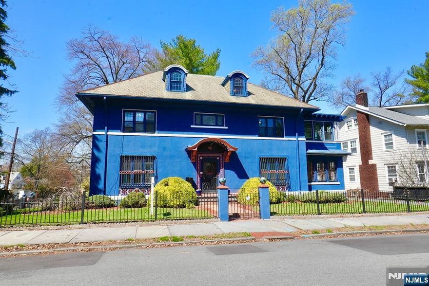 This exquisite Colonial, nestled in the heart of historic Forest Hills, captures timeless elegance with refined architectural details and abundant old-world charm. Built in 1927, this distinguished home welcomes you with a grand foyer that sets the tone for its classic sophistication. The grand living room, complete with a fireplace, offers a warm and inviting atmosphere perfect for gatherings. A beautifully renovated kitchen features a center island, creating a unique space ideal for both culinary pursuits and entertaining. The formal dining room adds to the home's charm and functionality. Additional highlights include 2 sunroom and a convenient powder room. The residence offers 7 spacious bedrooms, including a luxurious primary suite with a newly renovated bathroom and two closets, along with a total of 4.5 bathrooms. Situated on an oversized corner lot, the property boasts a marvelous backyard and a one-car garage. Located near Branch Brook Park, residents can enjoy stunning cherry blossoms in the spring and expansive green spaces year-round. The nearby light rail station provides easy access to Newark Penn Station, connecting you to NJ Transit and PATH trains for a seamless commute into Manhattan and beyond.