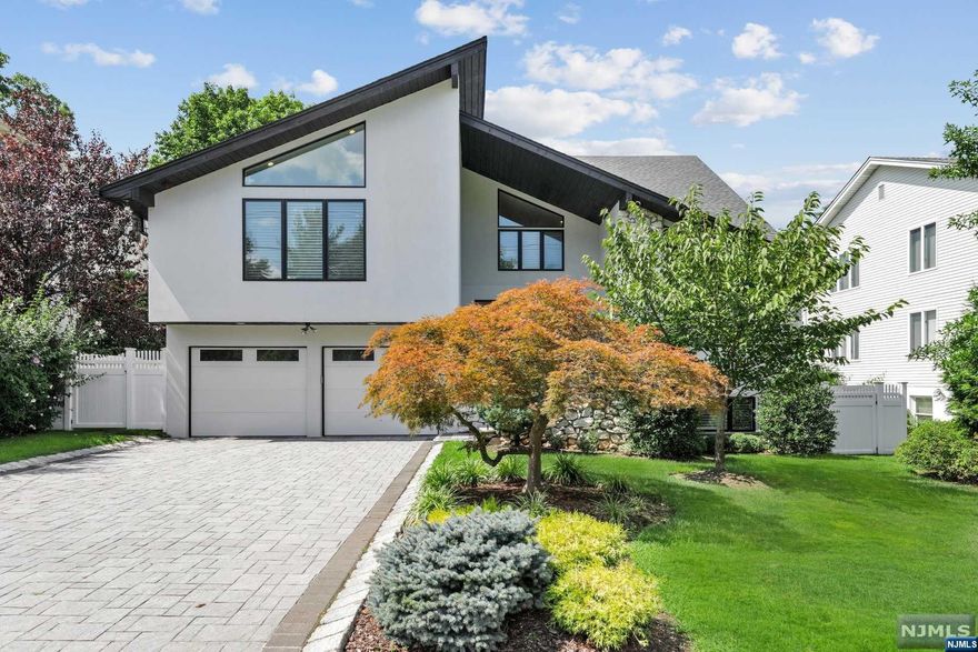 MOVE RIGHT IN to this fully renovated Contemporary Colonial located minutes from NYC in the low tax town of Englewood Cliffs. The modern design features an open floorplan with many high ceilings,large windows,a new kitchen and all new bathrooms. The Main level features a large Entrance Foyer with designer tile, Modern Kitchen open to a Great Room with vaulted ceiling and fireplace,Living Room,Dining Room and Powder Room. The Primary Suite boasts a large bedroom with vaulted ceiling,5 closets and a luxurious bathroom with double vanity,free standing tub,shower and radiant heat. The Lower level includes a Recreation room with several windows and an outside exit,a large Bedroom,1.5 Baths and an additional room. Additional upgrades include: new masonry stucco,paver driveway,Pella windows,roof,8 zone HW furnace,central A/C,electric,central vacuum, PVC fence and alarm. Low taxes and conveniently located close to public NYC transportation.