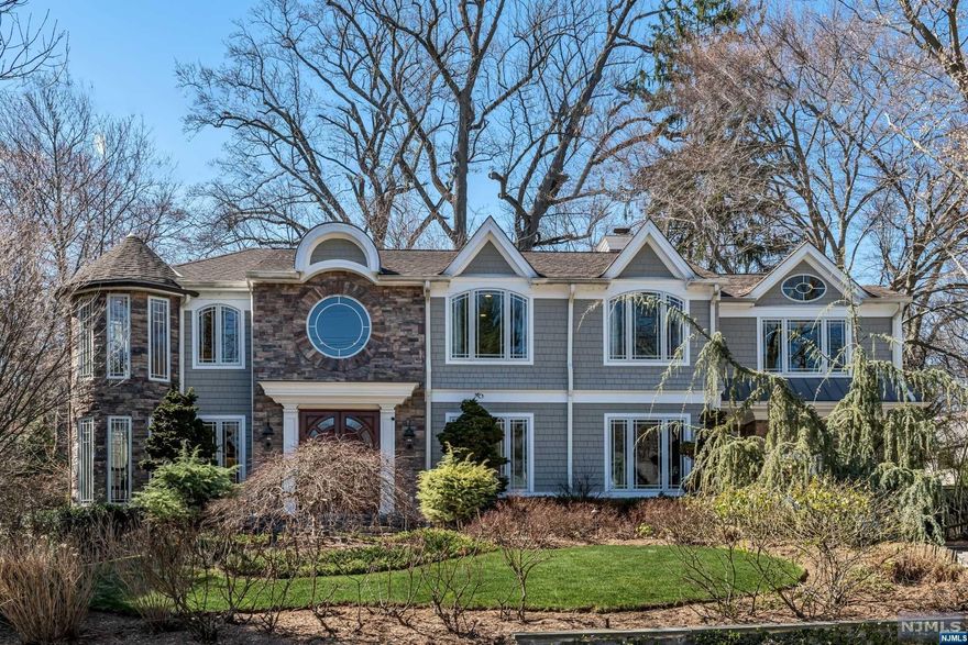 Dramatic focal points and luxurious details will make you fall for this 2007 new construction home on a tranquil half acre lot with close access to restaurants, shops, and commuter transportation. Marked by stunning light-filled Pella windows, exceptional millwork, and an open floor plan, the WOW begins in the 2-story foyer with curved staircase and onyx tile floor that opens to the living, dining, and family rooms. The contemporary kitchen boasts high end appliances, including Subzero refrigerator, 8-burner Wolf range and double ovens, and Miele dishwashers. The primary suite spans 800sf and includes a sitting room with private balcony overlooking the grounds. Another en suite and two more spacious bedrooms complete the second floor. The lower-level game room with pub area features a dramatic glass-walled wine cellar. New roof, gutters, and HVAC, plus multiple smart home technologies await the new owner. The perfect blend of elegance and comfortable everyday living!