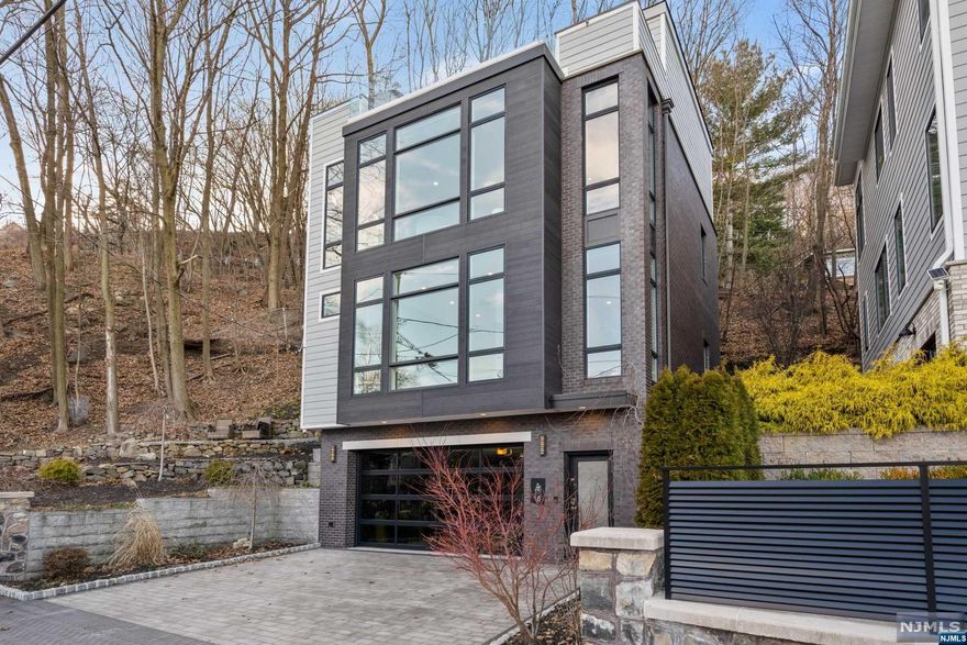 One of a Kind Single family on Private Dead End Street overlooking the Hudson River and George Washinton Bridge. No expense was spared during the construction, this home was built by a well known developer for himself. This home features 10 Foot Ceilings with Floor to Ceiling Windows. 3 Bedrooms (1 bedroom is on the top floor currently used as entertainment room) Features included in this home are 7 Inch White Oak Floors, Custom Motorized Blinds, Hidden Screen System, Thermador Appliances, Heated Floors, Smart Lighting System throughout, Steam Shower with Body Sprays, Instant Hot Water System, Wood Burning Stove in Living Room, Floating Staircases, with Glass Railings Throughout. Roof Deck has Custom Built-ins and 8 person Hot Tub overlooking the Hudson River. This home was featured in Homes Magazines Design issue.