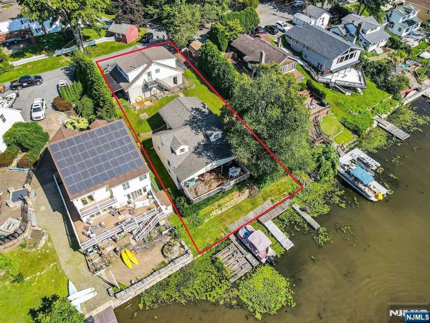 Discover The Hidden Potential Of This Exquisite Lakefront Gem! This Residence Has 4 Spacious Bedrooms And 2 Full Baths, Poised For A Remarkable Transformation On A Breathtaking Lakefront Parcel! The Main Level Features A Full Kitchen And Breakfast Nook, Complete With A Pantry And Charming Bay Window! An Expansive Living & Dining Area, Accompanied By A Full Bath And Two Generously Sized Bedrooms, Offers Ample Space For Relaxation And Entertainment! Ascend To The Upper Floor, Where A Primary Suite Awaits, Featuring An En-Suite Bath And A Convenient Walkthrough Closet! Abundant Storage, While A Magnificent Deck Extends From The Living Room, With Leading Stairs To A Lower Patio And A Private Pathway To The Dock And Water's Edge! The Full Walkout Unfinished Basement Presents Endless Possibilities! And Let's Not Overlook The Impressive 3-Car Garage, Complete With An Upper Room Ready For Your Creative Aspirations! Natural Gas, and 5 Bedroom Verified Septic! Bring Your Vision To Life!