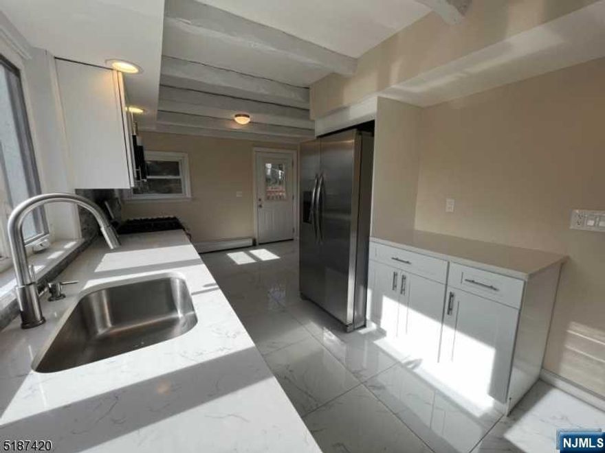 Welcome home to this updated 3 Bedroom/1.5 bath colonial style house, located on a spacious 50x150 lot with a large deck/backyard area & detached garage/storage shed. Main level features front lemonade porch, living room, dining room, and kitchen. Upstairs includes 3 full bedrooms, an updated full bath, and additional attic space. Unfinished basement includes laundry/utilities, half bath, and room for storage. Updated roof, paint, hardwood floors, kitchen, countertop, and SS appliances. Truly a must see. Great natural lighting throughout the house! Make this your home today! Low taxes! Close to schools, shopping, and house of worship. Motivated Seller! Seller concession available to assist buyer with mortgage rate buydown!