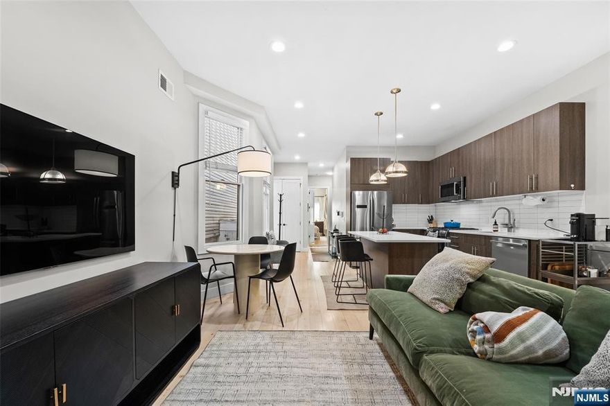 A standout duplex in the heart of Jersey City Heights, this fully reimagined home sets a new standard for modern living, complete with a private backyard. Thoughtfully renovated from top to bottom, the two-floor home pairs clean design with high-end finishes throughout. Wide-plank maple flooring, soaring 9.5â€ ceilings, oversized doors, and expansive Pella windows that fill the space with natural light, create an airy, inviting atmosphere. A spacious lower level provides flexible living, ideal for a home office, family room, or future third bedroom. The sleek kitchen features imported Italian cabinetry, quartz countertops, premium Bosch 800 Series appliances, and a built-in wine refrigerator. Enjoy the contemporary aesthetic of the three bathrooms, including a primary en-suite, each showcasing Hansgrohe fixtures and floating vanities. Smart home tech like the Nest thermostat, video intercom, and keyless Schlage entry offer convenience and peace of mind. Your living space extends outdoors with the private back yard; a rare opportunity for entertaining and relaxation alike. Ideally located, the home is a short walk from neighborhood staples like Washington Park, Riverview Park, the farmers market, coffee shops, fitness studios and more. With the local and NYC-bound bus lines less than a block away and the nearby 9th Street Light rail, take advantage of easy commuting while enjoying the quiet, residential feel of Webster Avenue.