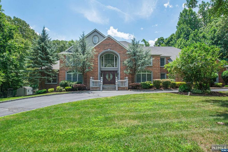 A grand circular driveway leads to the double door, two story entry foyer with sweeping twin staircases, immediately setting the tone for the home's grandeur. Retreat to tranquility in one of the 5 spacious BR suites, each w/ full bath for ultimate convenience.The primary bedroom suite features a double FPL, sep WICs and a spa-like bathroom w/ steam shower, dual sinks, and add'l FPL. Unleash your inner chef on an impressive 8-burner Thermador gas stove & double oven; the SubZero refrigerator & a designated pantry keeps your ingredients handy & a beverage fridge keeps your wine chilled to perfection. Indulge in ultimate comfort with multi-zone radiant heat t/o the home. Peace of s assured with a whole-house generator. The infinity pool/spa creates a resort-like atmosphere at home. Car enthusiasts will be thrilled by the main level 3-car garage and the add'l basement garage that has accomodated up to 22 sports cars, a haven for your prized collection!