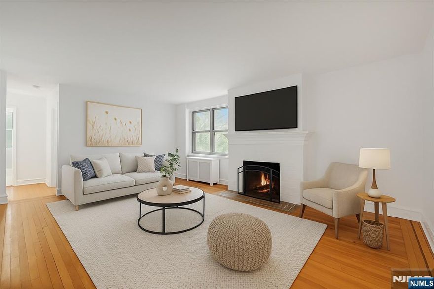 Located in Dwight Manor, this second-floor condo offers a bright layout with hardwood floors, updated finishes, and close proximity to local amenities. The spacious living room includes a wood-burning fireplace and large windows that provide natural light. An updated kitchen features stainless steel appliances, tile backsplash, and white countertops. Both bedrooms offer generous space and double windows. The full bathroom includes a tub/shower and classic tile. Additional features include radiator heat, window A/C units, tall ceilings, and an efficient floor plan with a defined dining area. On-site laundry, assigned outdoor parking, and elevator access add everyday convenience. HOA includes water, heat, hot water, common area maintenance, and trash removal. Approximately 0.1 mi to the NYC bus, 0.2 mi to Englewoodâ€™s shopping and dining district, 0.3 mi to grocery options, and 0.4 mi to nearby parks. Located near the center of town with access to major roadways and local services.