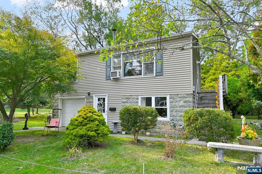 Well-Cared For Home With Flexible Living Space In Oakland, NJ! The Main Upper Level Has An Inviting Open-Concept Layout Featuring A Spacious Living Room With A Free-Standing Wood-Burning Stove And A Large Picture Window That Welcomes Abundant Natural Light. The Adjoining Eat-In Kitchen And Dining Area Flow Seamlessly Together, Offering Plenty Of Cabinetry, A Functional Center Island, And Sliding Glass Doors That Open To A Full-Length Rear Deck, Perfect For Outdoor Dining Or Relaxation. This Level Also Includes A Generously Sized Bedroom, A Full Bath With A Tub/Shower and Laundry and Utility Room. The Lower Level Expands The Home's Versatility With Its Own Private Entrance, A Kitchenette With Sink And Refrigerator, A Comfortable Living Space, 2nd Bedroom, A Bonus Room, And A Full Bath With A Stall Shower. This Space Offers Endless Potential, Whether For A Home Office, Recreation, Hobbies, Or Creative Uses. Set On A Peaceful Level Property With Mature Landscaping, Outdoor Seating Areas, And Tranquil Water Views, This Home Blends Convenience With Charm. Ideally Located Just 2 Miles From The Oakland Transit Park & Ride And Within Minutes Of Major Highways Including Route 287, Route 202, And The NY Thruway, This 2-Level Residence Is Perfect For Both Commuters And Those Seeking Flexible Living Options.