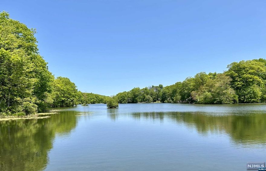 Vacation all year round in your own OASIS, Home has many recent updates that include, windows, roof, siding, heating, c-air, hot water heater, oversized shed. Huge master bedroom with high ceilings, large 3 season covered screened in deck overlooking private wooded back yard w/seasonal lake views. Relax in the lower level large family room, cool in the summer and cozy warm in the winter with the free standing pellet stove, dry bar and plenty of natural light coming through the newly installed Anderson windows, full bath and an laundry room across from a large pantry just off the Large oversized garage, featuring double doors that are oversized 9X8. Newly constructed oversized shed at the end of large driveway that can accommodate at least 5 cars. Home is located on a cul-de-sac street and within walking distance to beach at Barry Lakes, property within walking distance to Wawayanda State Park, close to all the lakes. Buyer may qualify for balance of current assumable loan at 3.5%