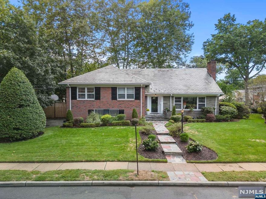 Prime location in the Westminster section of Hillside, NJ. An all brick, custom designed, expanded split level home offering 4,000 sqft of living space. 5 bedrooms, 3 Master En-Suites, (1 is perfect for an in-law suite with its own entryway) a total of 5 bathrooms, 2 kitchens, a Library with built-in shelving, a Grand room with a stunning marble fireplace, a spacious Family room, 2 car garage and 3 separate entrances!The home is East facing and the large windows infuses the whole home with tons of natural light. The library and the family room both lead to an all fenced in back yard on an oversized 100 x120 lot. The backyard is an absolute oasis with stunning tree canopy, stone patio with built-in grill, trail, raised garden beds, ideal for nature lovers. The wrap around driveway has a basketball hoop.The Home is efficient with central ac and central heat, unique slate roof known to hold for 150 to 200 years. The fully finished basement has previously been used as an in-law suite