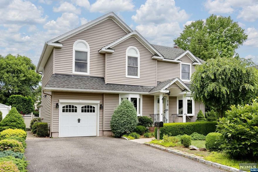 Welcome to 210 Kensington, a handsome thoughtfully expanded colonial on a quiet side street. Pristine curb appeal w/ manicured landscaping, wide driveway, charming architectural features and impeccable masonry. Enter the front door portico to tiled foyer area. Circular flow to very sunny LR and FDR to an open concept kitchen /den w/fireplace. The impressive kitchen truly is the heart of this home w/ custom cabinetry, expansive counter space, island w/ storage and seating and sliders to deck. French door to 4th BR or office, w/vaulted ceiling, and SLGD to deck. Side entry w/mudroom and full bath w/sky light. Primary ensuite addition w/ walk in closet, updated bath w/shower tub and double sink. 2 additional BRs and full bath. Beautiful HW floors. Full BSMT ready to be finished. Whole house generator. Fenced in yard is an oasis w/ spectacular gardens to be enjoyed in all seasons. Move in ready home w/ dream house potential just 3 blocks from NYC transport.