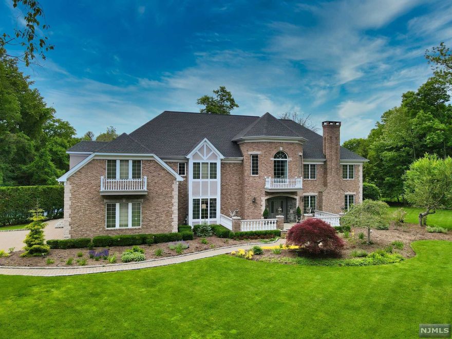 Welcome to a scenic entertainers' stage! Custom light brick manor faces Southeast on a one of a kind resort like property with partial seasonal lake views. A charming bluestone front porch leads into a 2 Story center hall with sweeping stairs. A palatial Great Room with floor-to-ceiling windows & jaw dropping natural stone fireplace ooze drama. An epic black galaxy wet bar & glass doors lead onto a renovated oversized deck. A lustrous & large modern eat in kitchen bears high end finishes, stainless steel appliances & offers gorgeous sunset dining! Formal Dining Rm, Living Rm, Executive Office & Nanny's Quarters perfect the 1st floor. Double stairs lead to a 2nd floor of 5 large Bedrooms and 4 Full Baths. A secluded Owner's Suite has a dressing area, ample closets & a relaxing spa-like bathroom with views! 2 of the 4 bedrooms have balconies with sliding doors. Bonus: Cabana/ She Shed next to tennis court & lake for a zen staycation! Close to NYC Transportation & Blue Ribbon Schools