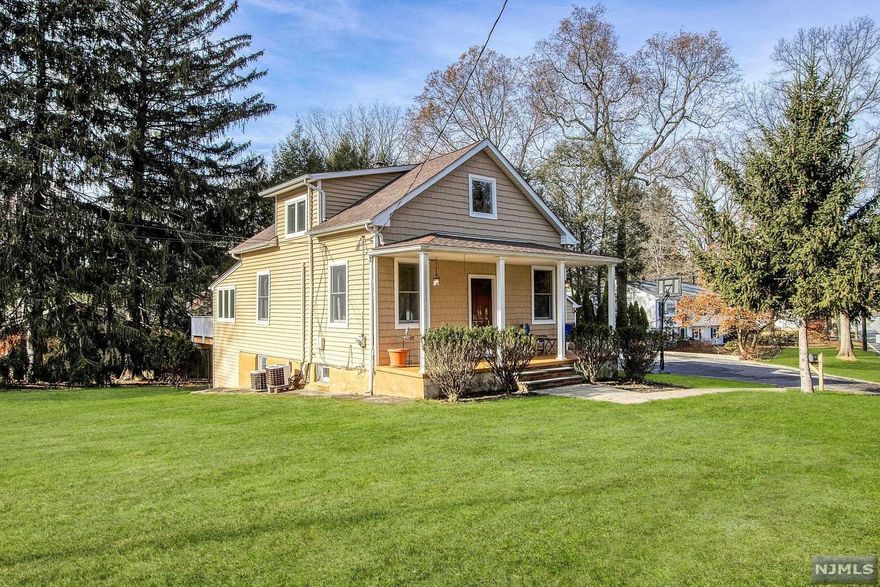 Picture perfect expanded colonial with lemonade front porch! Large and bright living room including sitting area. Spacious dining room leads into an open concept Immaculate kitchen featuring a large center island, granite countertops and stainless appliances. A few steps down offers a sitting area and expansive great room including wood-burning stove and vaulted ceiling. Large bedroom and half bath completes the first level. Second level offers three spacious bedrooms and an updated full bath. Fully finished lower level offers huge recreation area. A few steps down includes more living space with bonus rooms and full bath. Beautiful, lush property featuring a large deck and property--great for entertaining!