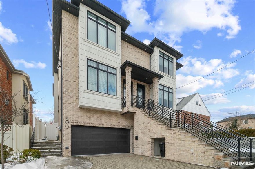 Built in 2019, this exceptional all-brick duplex blends modern comfort with timeless elegance in Cliffside Park, near Fort Lee border, just steps from NYC transit. The open-concept 1st floor has hardwood floors, cozy fireplace, spacious living and dining area perfect for relaxation and entertaining. The kitchen features a center island with breakfast area and opens onto a deck overlooking the backyard. Upstairs, the luxurious master suite boasts a tray ceiling, generous closet space, and en-suite bathroom. Two additional bedrooms share a full bath. Both 2nd-floor bathrooms are enhanced with radiant heat for added comfort. Laundry room on 2nd flr. A standout lighting package includes rope lighting and night lights throughout the 1st and 2nd floors. Lower level offers a recreation room with full bathroomâ€”perfect for a gym, office, or play areaâ€”along with backyard access and 2-car garage. With modern amenities, high-end finishes, and prime location, this remarkable home is a must-see!