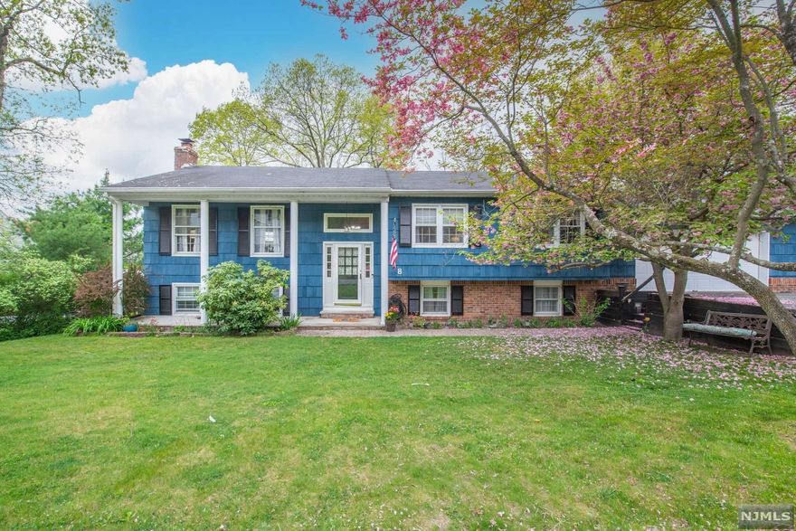This distinguished home sits on a tree-lined street in the highly desirable Awosting section, just minutes to Greenwood lake with seasonal lake views. Thoughtfully landscaped grounds invite you into the front yard. Upon entrance, you are warmly greeted by a bi-level style home with wood floors, fresh paint, and a bright and open floor plan seamlessly connecting the dining room to the kitchen then leading to the sunny backyard with a deck. Downstairs you'll find an oversized family room with fireplace another bathroom, bedroom, and a bonus room/fifth bedroom that provides additional room for flexibility. The backyard is level and large with plentiful space for a boat, gardening and entertaining.