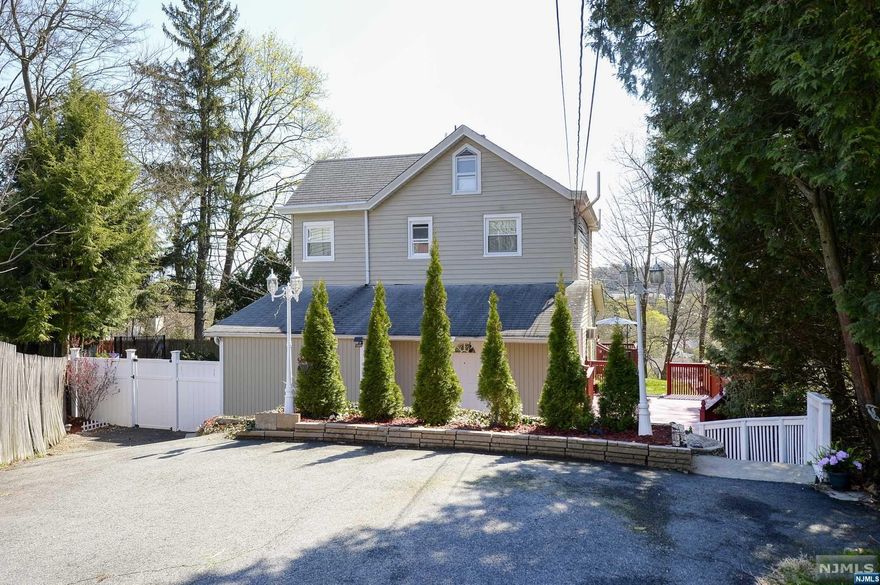 Charming colonial on huge lot! Spacious eat-in kitchen with SS appliances. Dining room with beautiful hardwood floor. Bright and airy living room with big picture window and access to the deck, perfect for entertaining! Convenient laundry room and office/den completes the first floor. 3 bedrooms and 1 bathroom upstairs. Plenty of attic storage. Private backyard with spectacular views! Fenced in side yard and attached storage shed. Close to NYC transportation, schools, and shopping!