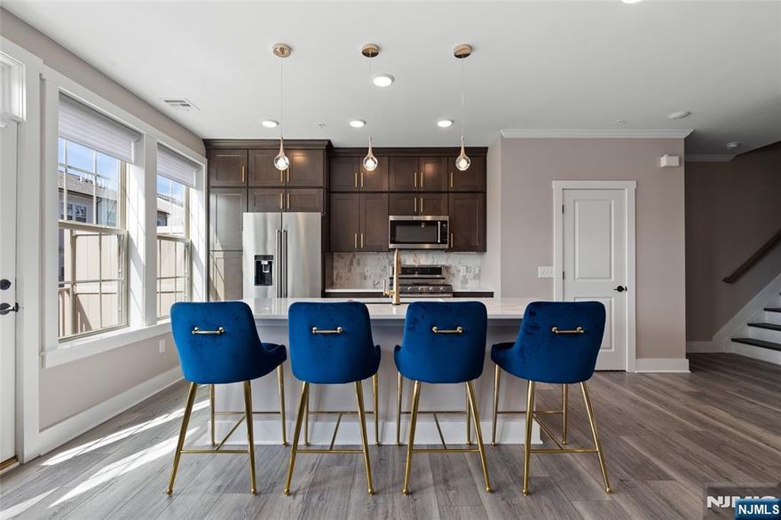 A beautifully upgraded 2 bedroom plus loft, 2 full and 1 half bath home located in the highly desirable LINK at Westmont. Built in 2022 & offering 1,771 SF of thoughtfully designed living space, enhanced w/ premium finishes & custom additions. The kitchen showcases higher-end KitchenAid appliances, a stunning marble backsplash, & elegant finishes that flow into a bright & open living area. Along w/ a balcony off the kitchen perfect for relaxing or grilling. Numerous improvements beyond the builder's standard features include vinyl flooring on the 2nd flr & stair treads, a built-out primary closet, high-end light fixtures, baseboard moldings, wainscoting, a mudroom bench, finished garage & a designer accent wall in the primary bedroom. Modern technology include a Ubiquiti network system w/ access points, Guardian managed security system w/ cameras & mechanical remote-controlled blinds. Builder upgrades from Pulte include an enhanced HVAC system w/ electronic air cleaner, zone dampener & humidifier, tray ceiling, luxury tile floors, tiled shower pan w/ built-in seat & soaking tub, double vanity guest bath & a garage hose bib. Offering valuable financial & long-term benefits; a tax abatement thru 2027 & a new construction structural warranty thru 2032, providing added peace of mind. Residents enjoy excellent amenities; guest parking, on-site shops, an athletic complex w/ baseball, soccer, pickleball, a dog park, playgrounds & close by tennis courts & Westmont Train Station.