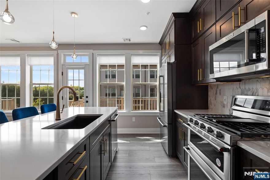 A beautifully upgraded 2 bedroom plus loft, 2 full and 1 half bath home located in the highly desirable LINK at Westmont. Built in 2022 & offering 1,771 SF of thoughtfully designed living space, enhanced w/ premium finishes & custom additions. The kitchen showcases higher-end KitchenAid appliances, a stunning marble backsplash, & elegant finishes that flow into a bright & open living area. Along w/ a balcony off the kitchen perfect for relaxing or grilling. Numerous improvements beyond the builder's standard features include vinyl flooring on the 2nd flr & stair treads, a built-out primary closet, high-end light fixtures, baseboard moldings, wainscoting, a mudroom bench, finished garage & a designer accent wall in the primary bedroom. Modern technology include a Ubiquiti network system w/ access points, Guardian managed security system w/ cameras & mechanical remote-controlled blinds. Builder upgrades from Pulte include an enhanced HVAC system w/ electronic air cleaner, zone dampener & humidifier, tray ceiling, luxury tile floors, tiled shower pan w/ built-in seat & soaking tub, double vanity guest bath & a garage hose bib. Offering valuable financial & long-term benefits; a tax abatement thru 2027 & a new construction structural warranty thru 2032, providing added peace of mind. Residents enjoy excellent amenities; guest parking, on-site shops, an athletic complex w/ baseball, soccer, pickleball, a dog park, playgrounds & close by tennis courts & Westmont Train Station.