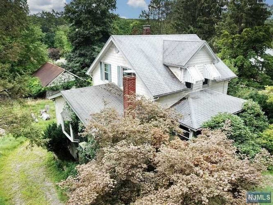 VALUE IS IN THE LAND! Large property just under an Acre (approx 196 x 220). Great location with easy access to Garden State Parkway. This property has 3 structures all of which are being sold AS IS for renovation, expansion or removal: 3 BR/1 Bath house, detached 2 Car Garage with loft and an additional building. There is also an enclosed dog pen on the property. Contact the town for approval or possible sub-division/variance. Clear the land and build your dream home (or possibly 2?)! There is known mold in the house and basement due to a burst pipe in bathroom and leak in roof. Structures have NOT been deemed safe to go inside. All house and outbuilding contents are included. BEING SOLD AS-IS.