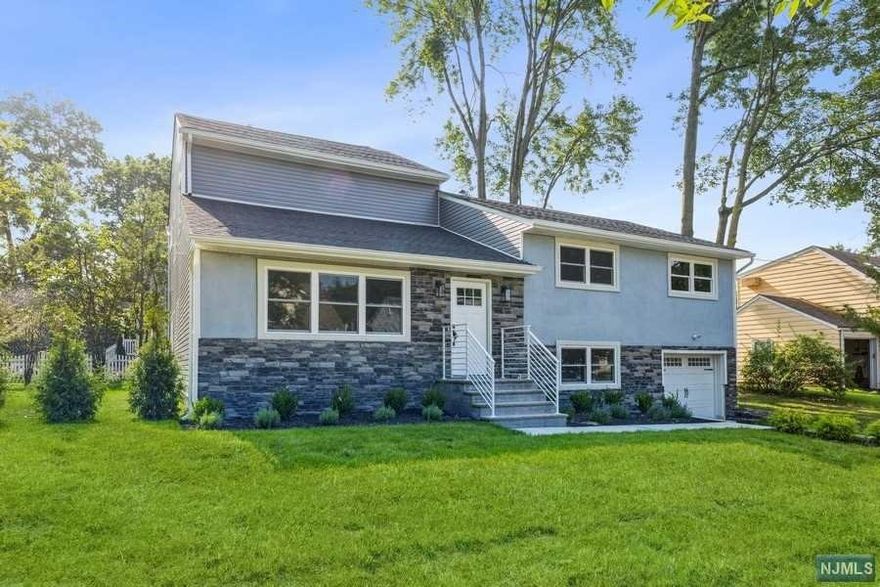 Stylishly renovated in a prime location! Completely updated Split Level home just for you!! four bedrooms, two and a half bathrooms, an and attached one-car garage sits on a manicured lot in a sought-after community. This beautiful home features custom trim work, rich hardwood floors, a fireplace, coffered ceilings, to an open floor plan. Foyer with built-in storage, open layout on the main level including a formal dining room w/custom trim work. The flow continues to an eat-in kitchen w/ quartz counters, custom cabinetry, and an oversized center island with seating. The kitchen is open to the living room vaulted and coffered ceiling, windows all around, and gas fpl. 2nd fl. 3 bdrms & a full bathroom. 3rd level, Master bdrm suite w/trim work, enormous windows, and a state-of-the-art en suite bathroom with a soaking tub. The lower level, half bathroom, family room. Close to shops, schools and transportation.