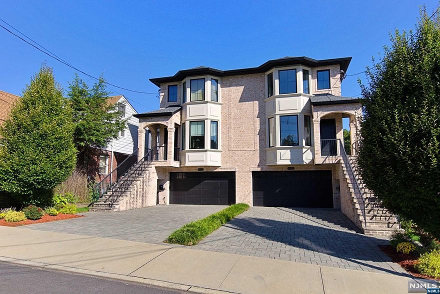 Fantastic, Side by side, 2 family home built in 2017 with a unique, huge, back yard! Located in the heart of Fort Lee this home is close to schools, shops, houses of worship and NY transportation. Both sides include: Ground floor; family room/4th bedroom, powder room, walk in closet, utility room, true 2 car garage, sliding doors to large patio and yard. First floor has living room with fireplace, dining room, powder room, eat in kitchen with stainless steel appliances and Quartz counters, sliding doors to large deck. Second floor has 2 large bedrooms, family full bath, laundry room, primary bedroom with vaulted ceilings, primary bathroom. Some highlights include; large yard, 3 zone heating and 2 zone ac, 2 car garage, underground sprinklers, electric car charging port, all closets are finished with built in cabinetry and so much more. Don't miss out on this great opportunity!