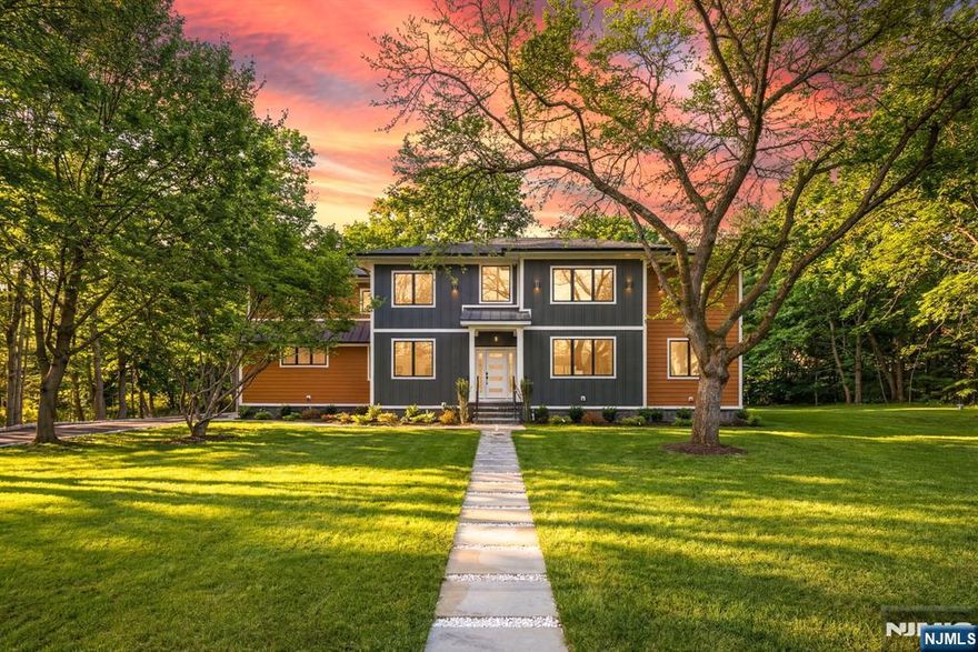 WELCOME TO THE ULTIMATE IN LUXURY LIVING. Set on nearly an acre in one of Mahwahâ€™s most picturesque settings, this newly constructed colonial offers refined design and thoughtfully crafted living space. A dramatic two-story foyer introduces an airy, light-filled layout designed for both everyday comfort and elevated entertaining. The main level flows seamlessly between formal and casual spaces, including an inviting living room and spacious family room. At the center, the chefâ€™s kitchen features premium ZLINE appliances, an oversized island, and expansive quartz countertops, blending style and function. The adjacent dining area opens to a Trex deck, creating effortless indoor-outdoor living. Two versatile rooms on the first floor offer ideal space for bedrooms or a home office, along with a full bath, powder room, and mudroom. Upstairs, each bedroom is designed as an en-suite, offering comfort and privacy. The primary suite is a true retreat with soaring ceilings, a sleek fireplace, and a private balcony. The spa-like bath features a soaking tub, dual vanities, and a custom walk-in closet. A second-floor laundry room with pet wash adds convenience. The fully finished lower level includes a movie theater, recreation space, and walkout access to the backyard. A three-car garage completes this exceptional home offering luxury, space, and modern living in one of Bergen Countyâ€™s most desirable locations.