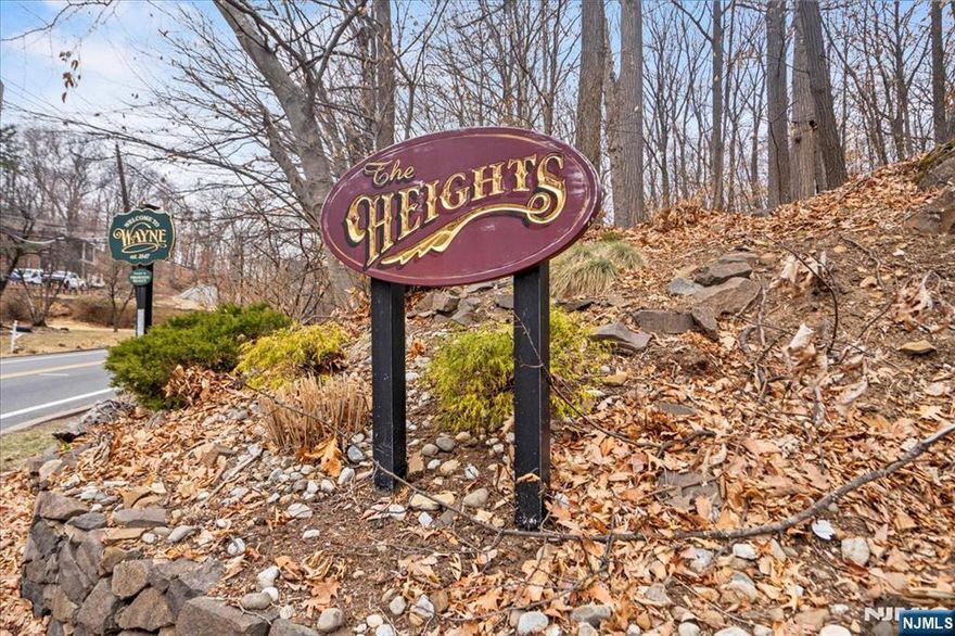 Itâ€™s all about the spectacular views from this gorgeous end unit at The Heights. Step into this inviting sun-filled open floor plan layout with high ceilings, wood flooring, throughout the main living area, an oversized LR featuring a corner fireplace. Sliding doors off the LR open to a private deck. Eat-in-kitchen with granite counters, under cabinet lighting, SS appliances, white cabinetry open to the DR. 1-car attached garage entrance off the kitchen & a powder room complete this level. On the second level you will find an inviting master suite with high cathedral ceiling, skylight, large WIC, private en-suite w/stall shower, whirlpool tub. Large second bedroom & spacious office share a renovated full bath. Convenience is key with the 2nd Floor laundry. Storage galore, crown molding, central vac, new HVAC are just a few of the many upgrades this unit has. Convenient location puts you minutes from NYC commuting options, major highways, shopping, dining & more! Don't Miss This One!