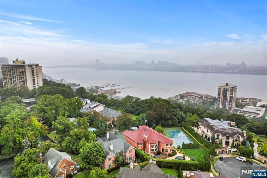 Located in Fort Lee's desirable Bluff section, this expansive 5 bedroom, 7.5 bath center hall colonial is situated along the Palisades Cliffs w/NYC & Hudson River views from almost every room. Over-sized property. 2-story entry foyer. Open layout w/windows along the entire back of the home highlighting the views! 1st floor features a home office w/gas fireplace, family rm, DR, gourmet EIK w/granite countertops, SS Viking appliances & wine fridge, full bath, laundry room & formal LR w/fireplace. Attached 3 car garage. Large MBR suite w/sitting room, fireplace, large full bath, 2 enormous walk-in closets & dressing area. 3 additional BRs each w/full baths. Huge finished basement offers an office, rec room, additional BRs, and 3 more full baths. At approximately 5,500 sq. ft., this home offers a private oasis with quick & easy access into NYC.